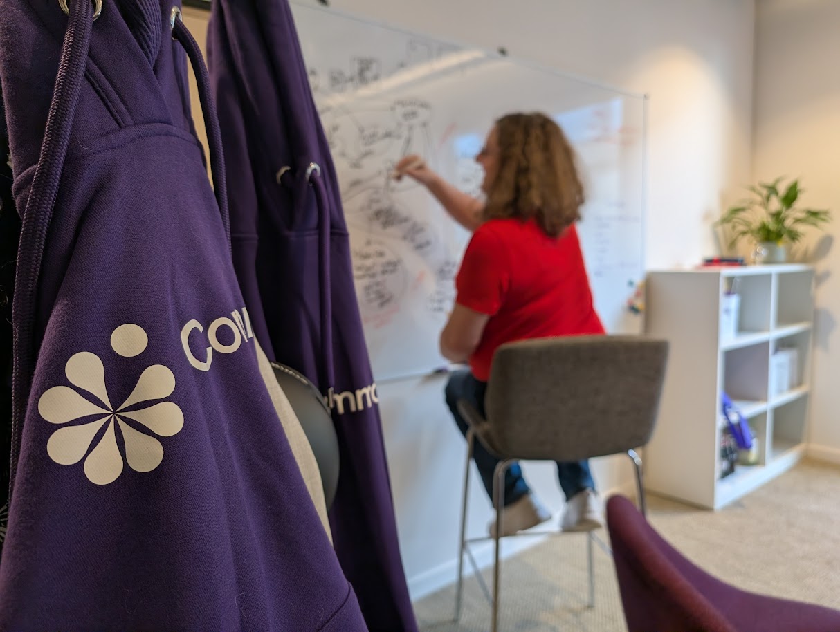 A CommonAI team member working at a whiteboard